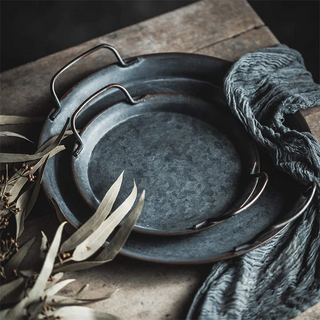 Curated collection of wooden serving boards and trays featuring organic textures, natural finishes, and understated elegance for mindful table styling