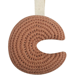 Handmade crochet moon pacifier clip in soft cotton yarn, attached to a pacifier—gentle and soothing for babies, styled in a natural nursery setting.