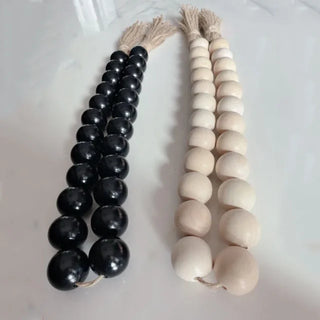 Oversized black or natural wooden bead garlands with hemp tassels, a rustic boho accent for trays, planters, shelves, or wall decor.