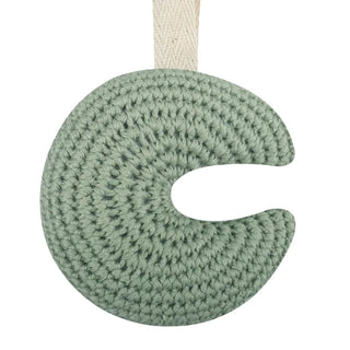 Handmade crochet moon pacifier clip in soft cotton yarn, attached to a pacifier—gentle and soothing for babies, styled in a natural nursery setting.