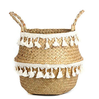 Handwoven natural seagrass storage basket with handles, perfect as a stylish hanging basket, pot planter, or decorative storage solution. This eco-friendly basket, adorned with charming tasselled fringe, adds a natural boho touch while keeping your space organized. Shop handcrafted storage baskets at our natural homeware store.