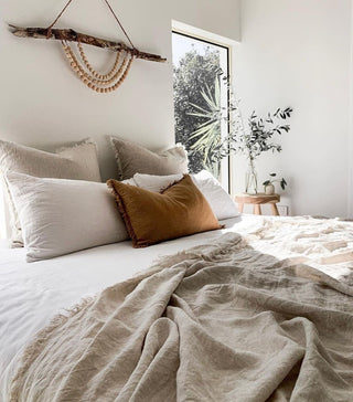 Bedroom styled with handmade homeware including linen bedding and natural textures