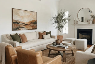  Living room styled in autumn colours, featuring cotton cushions, neutral sofas and natural homeware textiles.