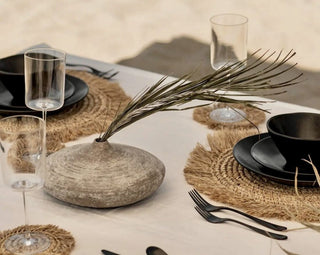 Elegant ceramic dinnerware, cups, trays, and natural table linens arranged with timeless simplicity for a refined, earthy dining experience