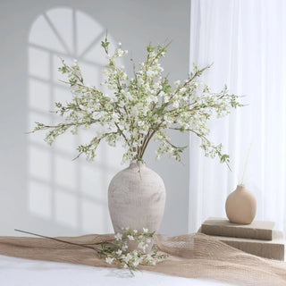 Rustic vase with spring florals within a minimalist interior.
