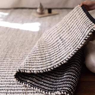 Hand-braided black and white jute and cotton rug. Sustainable, durable, and reversible—perfect for Japandi, Scandi, and modern interiors.