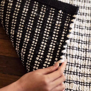 Hand-braided black and white jute and cotton rug. Sustainable, durable, and reversible—perfect for Japandi, Scandi, and minimalist interiors.