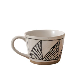 Hand-painted stoneware coffee cup with satin-speckled glaze and graphic motif.