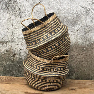 Handwoven natural and black seagrass storage basket with handles, perfect as a stylish hanging basket, pot planter, or decorative storage solution. This eco-friendly, two-tone basket with a tribal motif adds a boho touch to your home décor while keeping your space organized. Shop handcrafted storage baskets at our natural homeware store.