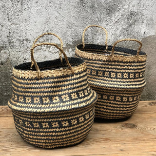 Handwoven natural and black seagrass storage basket with handles, perfect as a stylish hanging basket, pot planter, or decorative storage solution. This eco-friendly, two-tone basket with a tribal motif adds a boho touch to your home décor while keeping your space organized. Shop handcrafted storage baskets at our natural homeware store.