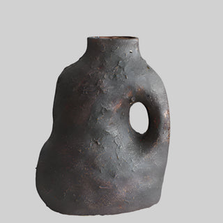 Nara handmade ceramic ornamental vase with an organic, asymmetrical shape and a textured blackened clay finish with bronze undertones. The vase features a sculptural handle-like cutout and a rustic, wabi-sabi aesthetic. Perfect for Japandi, modern, and minimalist home décor.