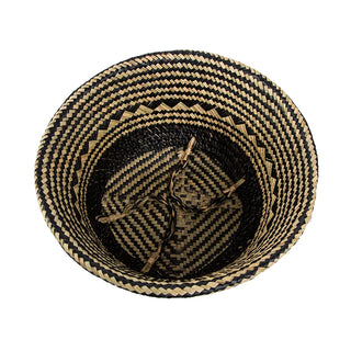 Handwoven natural and black seagrass storage basket with handles, perfect as a stylish hanging basket, pot planter, or decorative storage solution. This eco-friendly, two-tone basket with a tribal motif adds a boho touch to your home décor while keeping your space organized. Shop handcrafted storage baskets at our natural homeware store.
