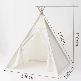 Small whimsical cotton teepee play tent with pom poms for children. Boho-style play tent for nursery or bedroom.