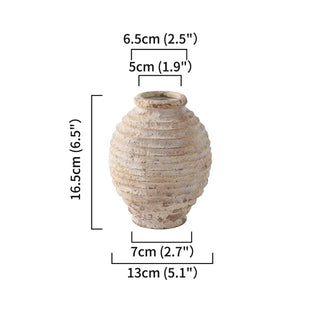 Ribbed Ceramic Vase, crafted from natural ceramic and finished in a distressed antique white wash. It adds depth and character to any setting. With its elegant silhouette and neutral tones, it complements a variety of arrangements, making it an ideal centre piece for both modern and traditional natural home décor. Perfect as a stand-alone ornament or paired with other decorative accessories.