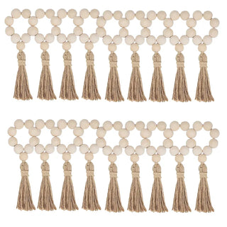 Set of eighteen handmade wood bead napkin rings with whitewashed wood and hemp rope tassels, perfect for natural and eco-styled table settings.