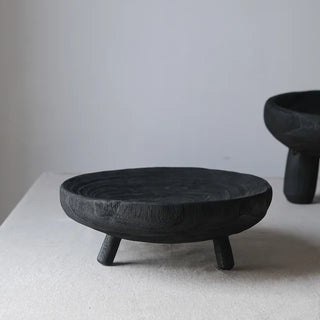 Black handcrafted wooden decorative bowl with tripod base, made from sustainable tung wood-stylish deco piece for shelves, consoles or table tops.
