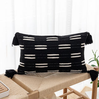Ayat Linen Blend Cushion Cover – decorative black and white boho cushion with tasselled corners. Made from a soft linen-cotton blend, featuring an ethnic-inspired pattern for a natural home décor touch.