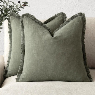 Olive green fringed cotton cushion covers, made from 100% natural cotton for a soft and breathable feel. Featuring elegant ruffled edges, these timeless cushion covers are available in two sizes for flexible styling in any home décor.