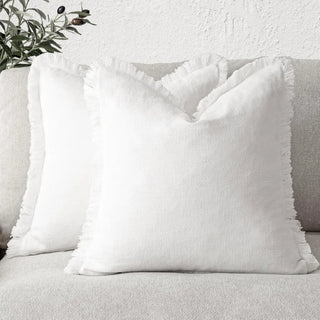 White fringed cushion covers, made from 100% natural linen cotton blend for a soft and breathable feel. Featuring elegant ruffled edges, these timeless cushion covers are available in two sizes for flexible styling in any home décor.