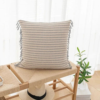 Handwoven Nura Cotton Cushion Cover with embroidered grey stripes and fringe tassels. Made from a breathable cotton-linen blend for a soft, cozy, and stylish home décor touch. Perfect for modern and boho interiors. Shop sustainable cushion covers online.