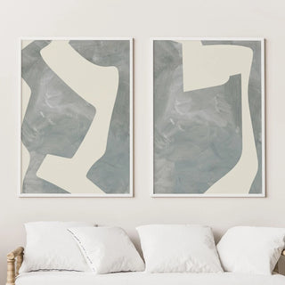 Set of two abstract geometric canvas prints featuring soft cream shapes over a textured grey background, perfect for minimalist and modern organic interiors.