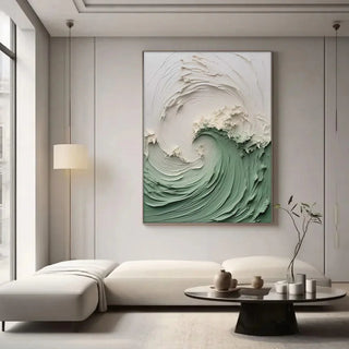 Abstract ocean wave canvas wall art in green and white in a minimalist living room setting.