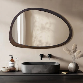 Asymmetrical vanity mirror with dark wood frame
