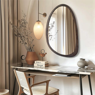 Asymmetric wooden framed wall mirror above dressing table