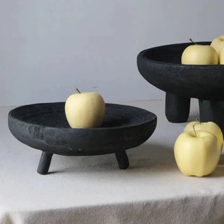 The Akira Wooden Deco Bowl, crafted from sustainable tung wood, features a rustic, raw design that adds harmony and balance to natural home décor. This handcrafted piece serves as both a decorative accessory and practical display item, creating an engaging centre piece for any space. It can also be used as a fruit bowl, tall ritual bowl or to display small trinkets.