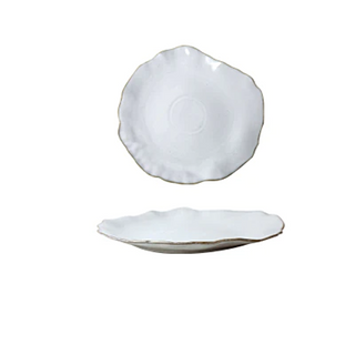 Hand-glazed ceramic plate with a soft organic shape and hand-painted rim, ideal for serving meals in an elegant, modern table setting.
