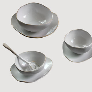 Elegant ceramic spoon with hand-glazed finish and painted rim, featuring an organic shape—designed to complement modern artisanal dinnerware.