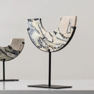 Arched marble decorative sculptures with natural stone veining.