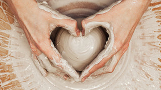 Natural clay on a potter's wheel - handmade pottery.