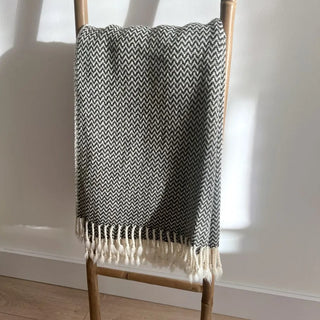 Merino wool throw draped over bamboo ladder.