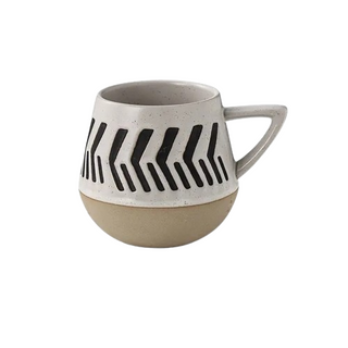Nordic-inspired handmade clay mug with a white satin-speckled glaze and a black graphic motif, perfect for tea or coffee.