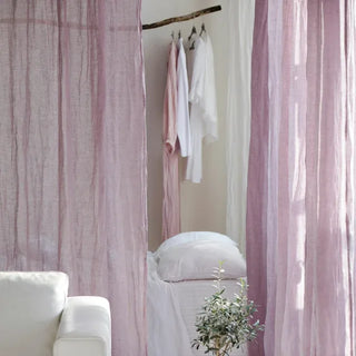 Pink linen rod pocket curtain hanging in a sunlit minimalist bedroom — natural window treatment with soft drape and textured finish.