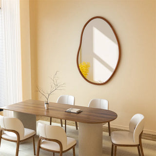 Sculptural wooden mirror above dining table