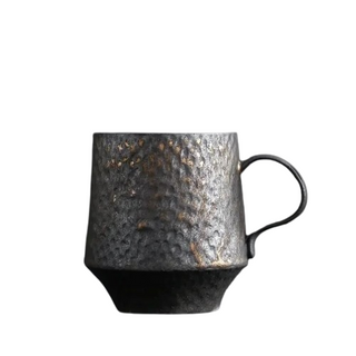 Handmade stoneware mug with textured surface and a bronze metallic glaze, inspired by wabi-sabi aesthetics.
