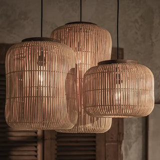 Cluster of natural rattan and teak pendant lights with organic shape — handmade ceiling lamp for minimalist or coastal interiors.