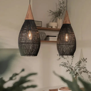 Black handmade rattan and teak pendant light with tear drop shape — artisan ceiling lamp for Wabi Sabi or Boho interiors.