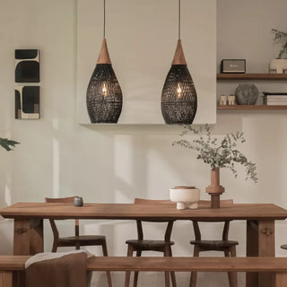 Black handmade rattan and teak pendant light with tear drop shape — artisan ceiling lamp for Wabi Sabi or Boho interiors.