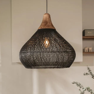 Black handmade rattan and teak pendant light with bell shape — artisan ceiling lamp for Wabi Sabi or Boho interiors.