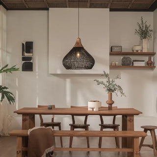 Black handmade rattan and teak pendant light with bell shape — artisan ceiling lamp for Wabi Sabi or Boho interiors.