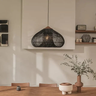 Black handmade rattan and teak pendant light with fish trap shape — artisan ceiling lamp for Wabi Sabi or Boho interiors.