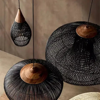 Black handmade rattan and teak pendant light with organic shapes — artisan ceiling lamps for Wabi Sabi or Boho interiors.