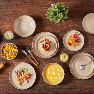 Modern beige tableware set styled on a wooden dining table