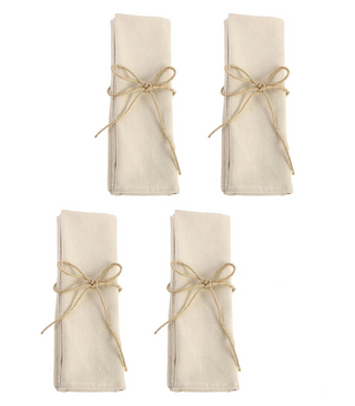 Set of four beige cotton napkins tied with twine for a natural table setting.