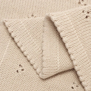Gigi cotton knit baby blanket in soft pastel beige.