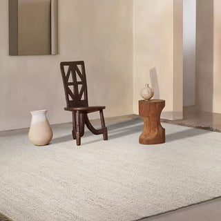 Beige woven jute and cotton rug styled in minimalist living space Arkaim Home