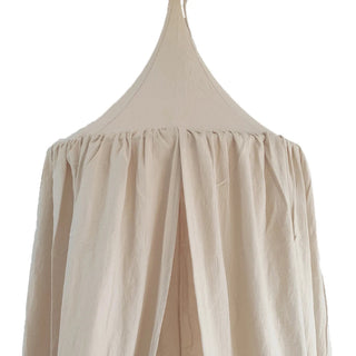 Beige cotton nursery canopy with a conical top and draped fabric, ideal for creating a cosy reading nook or dreamy play space in a child's room.